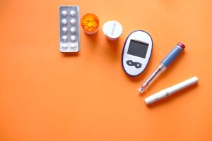 Diabetes management supplies including a glucose monitor and insulin pens