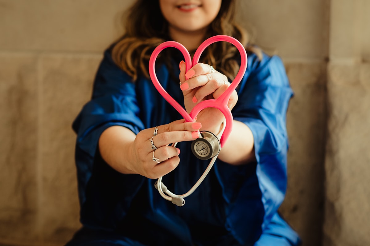 Nurse holding a heart-shaped stethoscope, symbolizing cardiac care